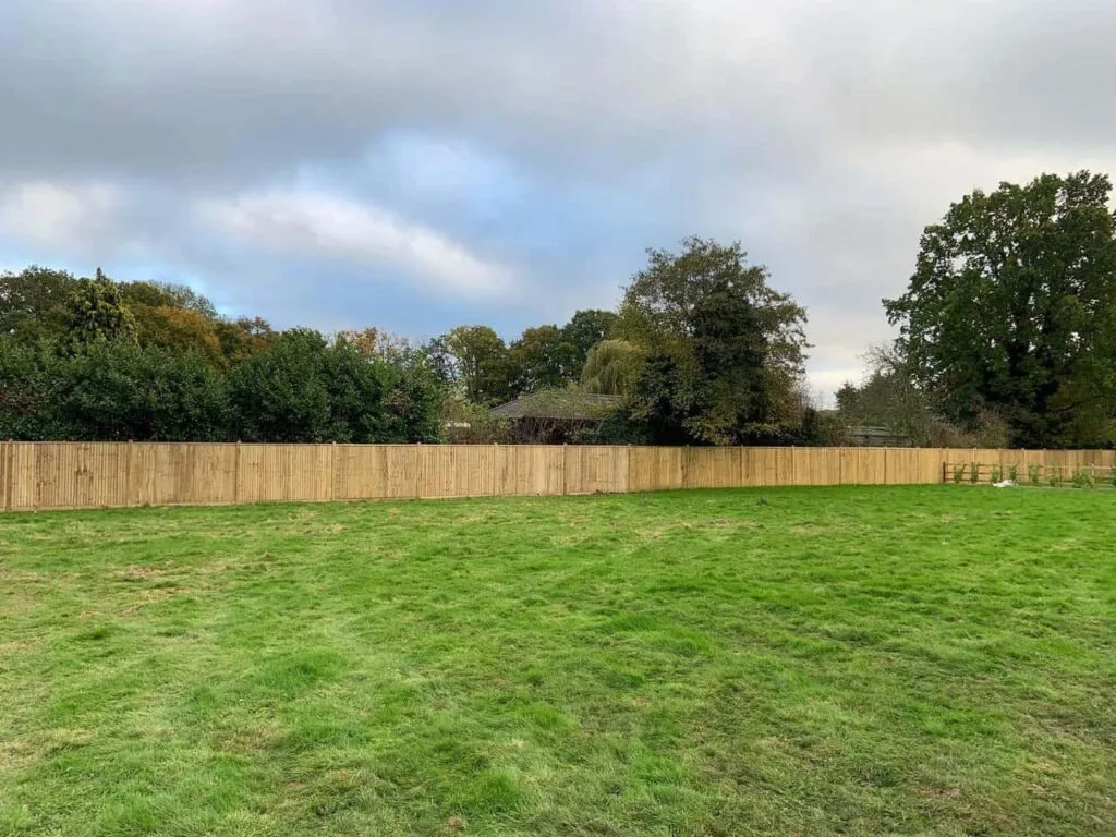 This is a photo of feather edge fencing installed around the edge of a field by Fast Fix Fencing Maidstone